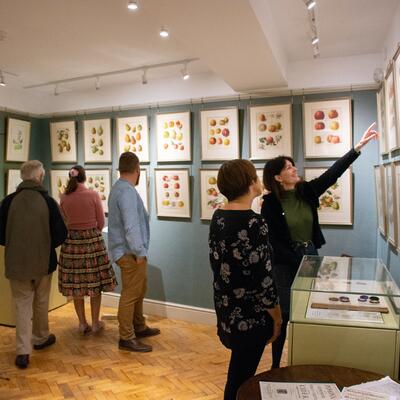 Visitors enjoying an art exhibition at the Museum of Cider